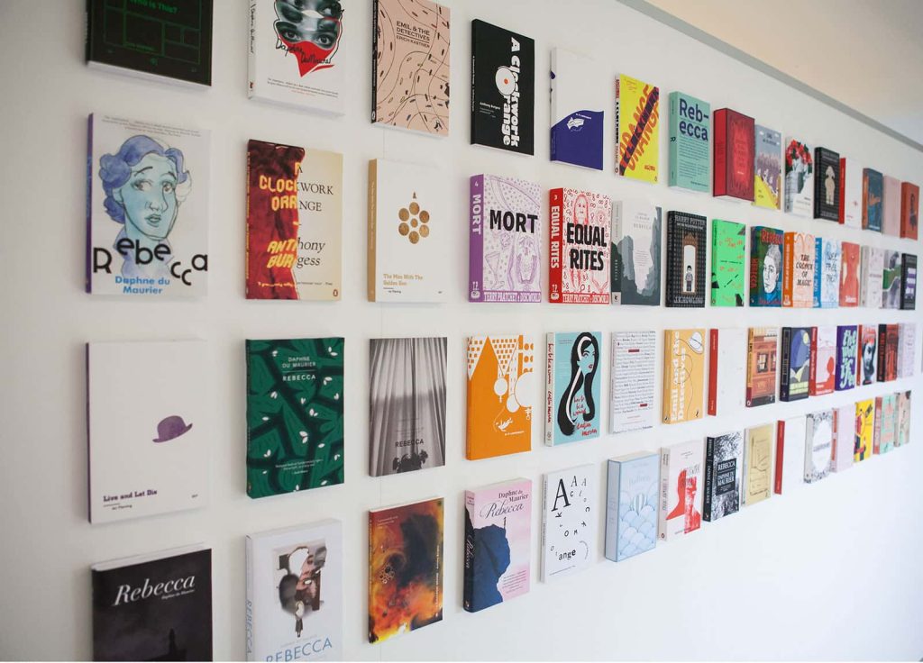 Image of designed publications mounted on a wall