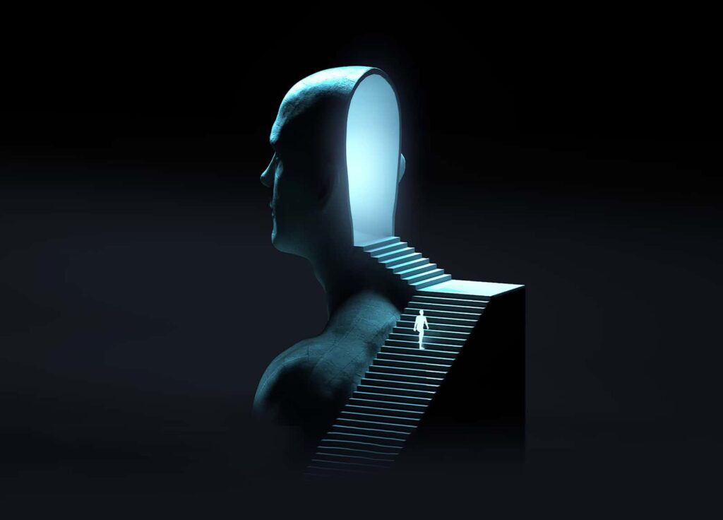 A surreal image shows a giant human head with an open back and stairs leading into it. A small person ascends the steps toward the illuminated interior, symbolizing exploration of the mind. The scene is set against a dark background.
