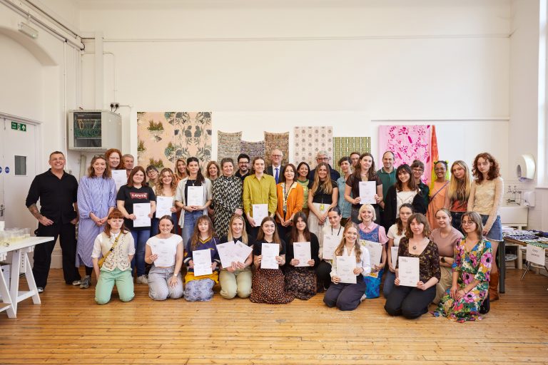 A photo from the Textile Design Industry Awards 2024. The image is of the students, staff and judging panel in a group and smiling at the camera.