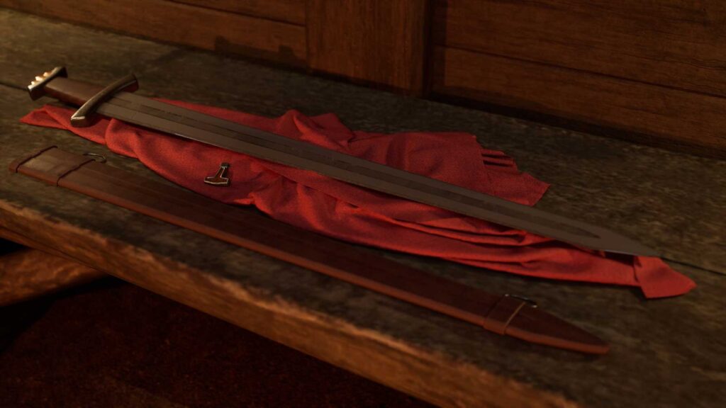 A sword rests on a red cloth on a wooden surface.